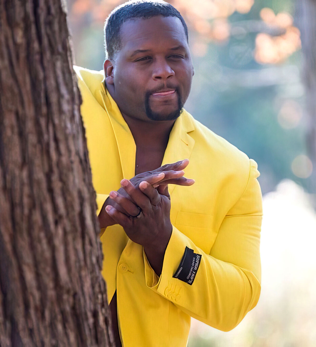Spice adams hiding behind a tree