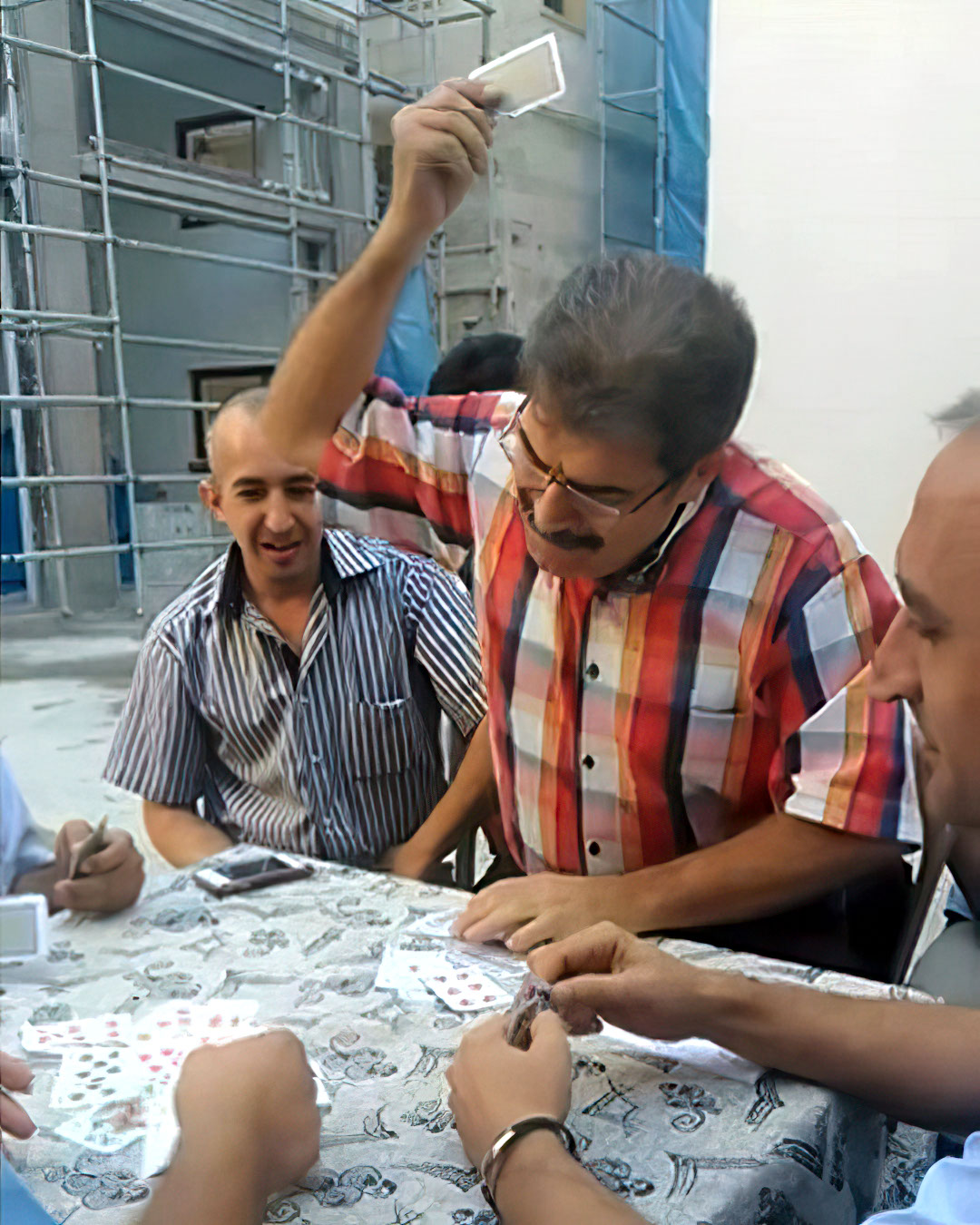 Man smacking cards down on table