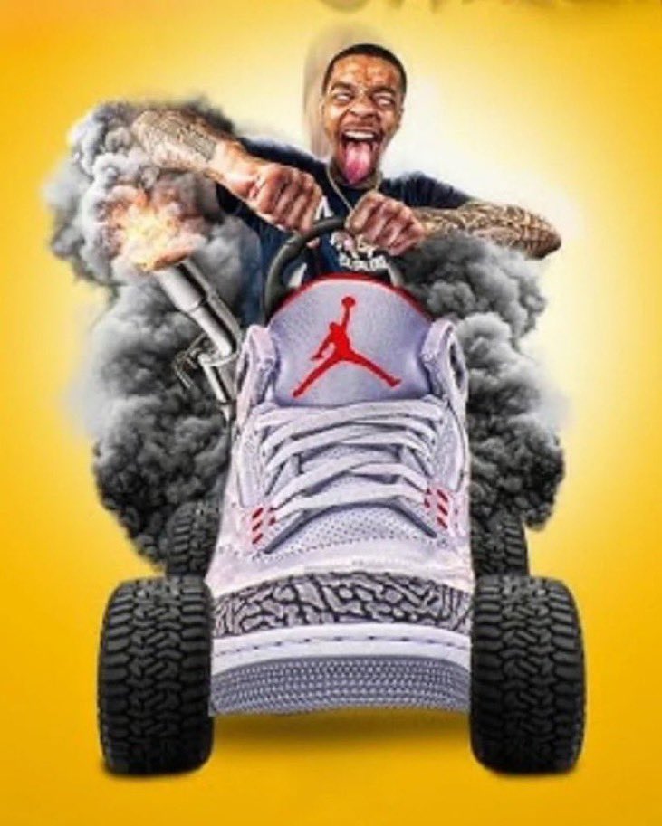 Un homme souriant conduit une chaussure Air Jordan comme une voiture, des flammes et de la fumée sortant du pot d'échappement